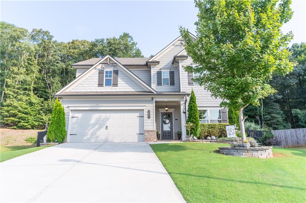 a front view of a house with garden