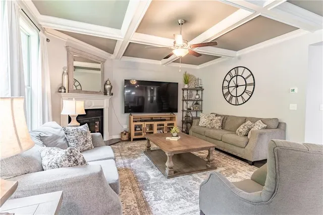 a living room with furniture and a chandelier