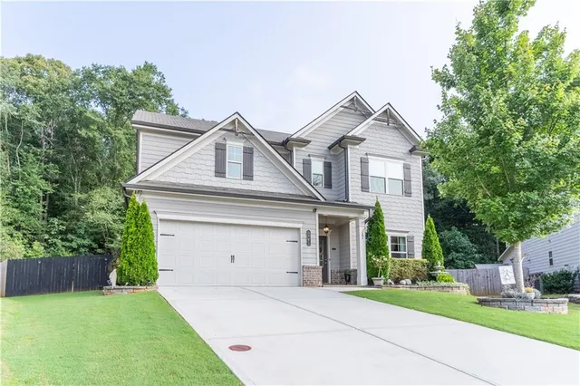 a front view of a house with a yard and garage