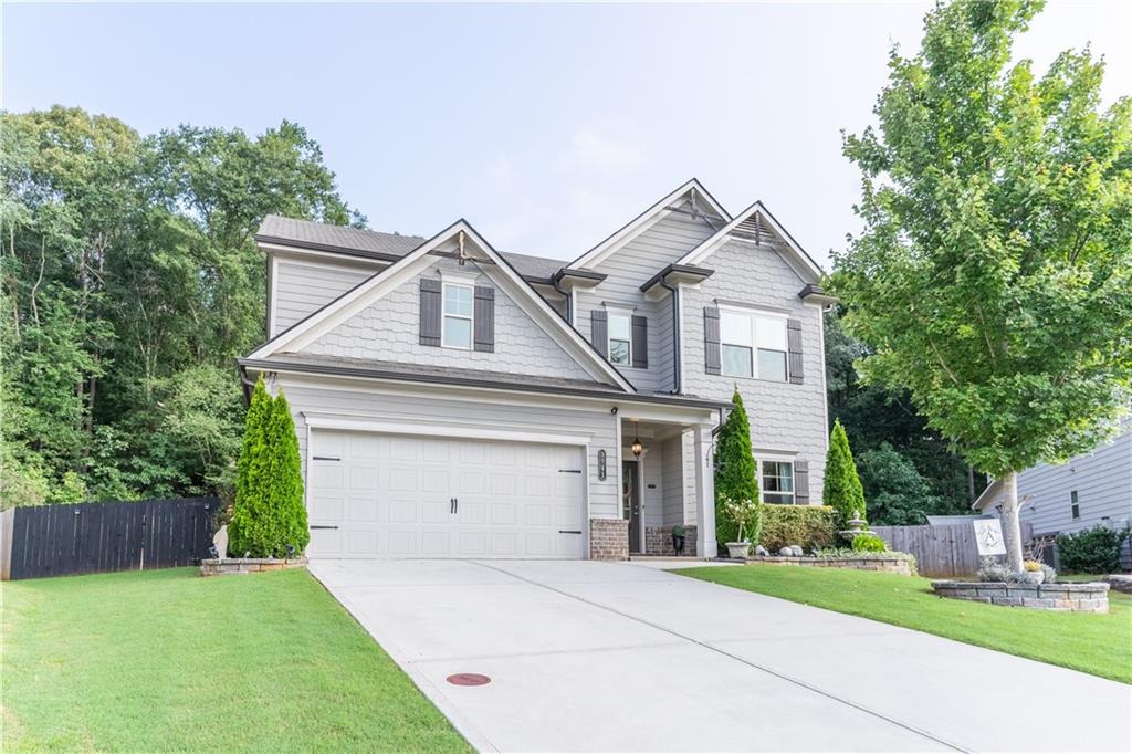 3041 Vista Ridge Braselton, GA 30517 - Photo 2 of 56 a front view of a house with a yard and garage
