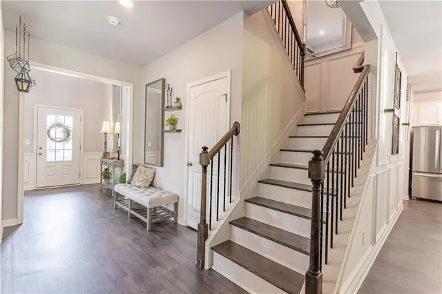 a bedroom with a large bed a flat tv screen and furniture