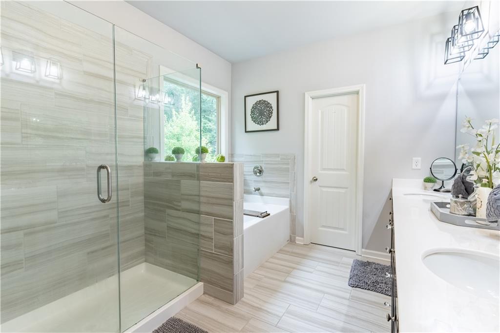 3041 Vista Ridge Braselton, GA 30517 - Photo 29 of 56 a bathroom with a bathtub shower sink and toilet