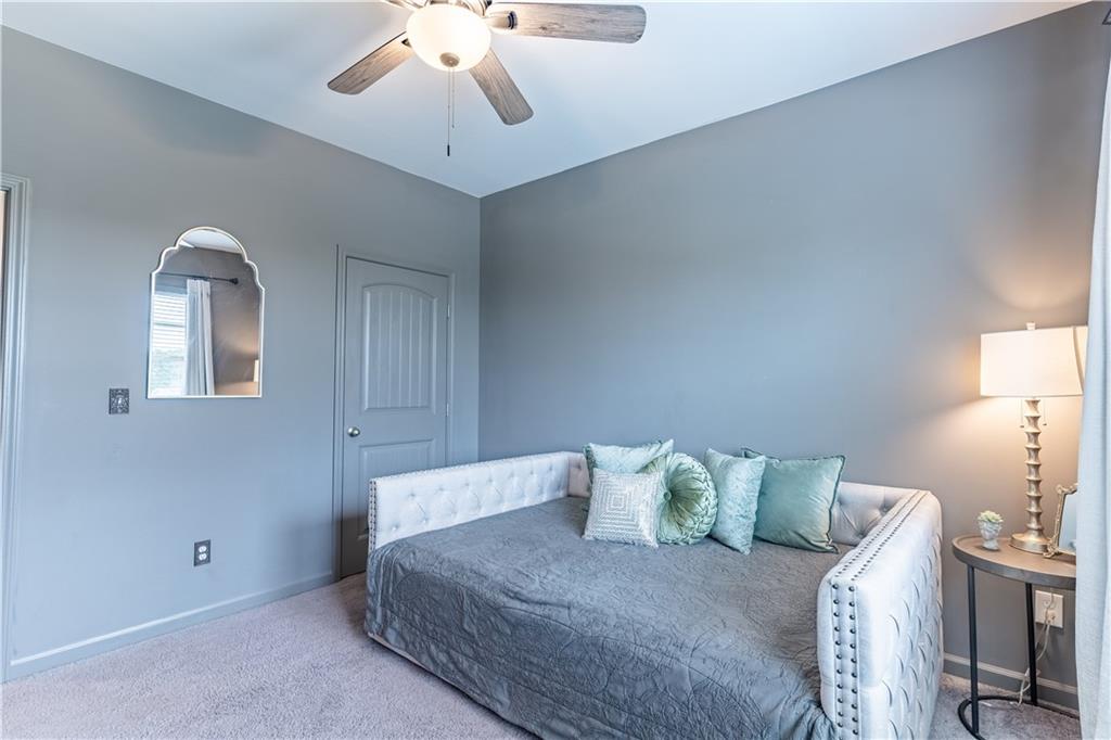 3041 Vista Ridge Braselton, GA 30517 - Photo 37 of 56 a bedroom with a bed and a chandelier