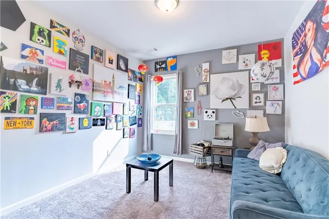 a living room with furniture and a floor to ceiling window