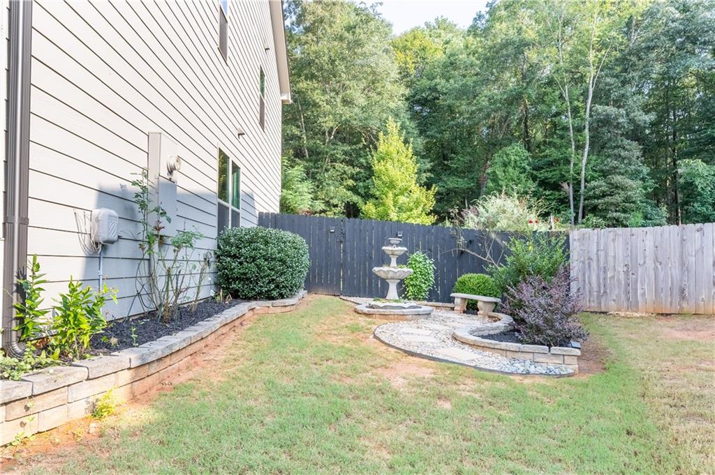 3041 Vista Ridge Braselton, GA 30517 - Photo 50 of 56 a view of a backyard with a potted plants and large tree