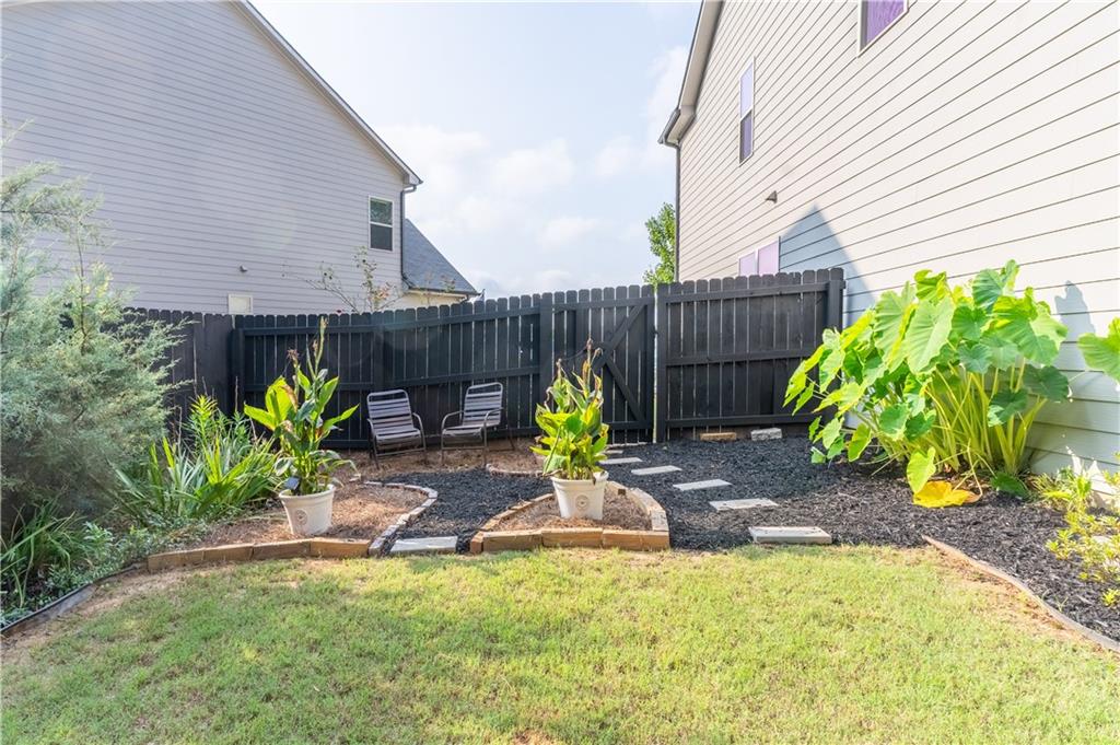 3041 Vista Ridge Braselton, GA 30517 - Photo 51 of 56 a view of a backyard with chairs and flower plants
