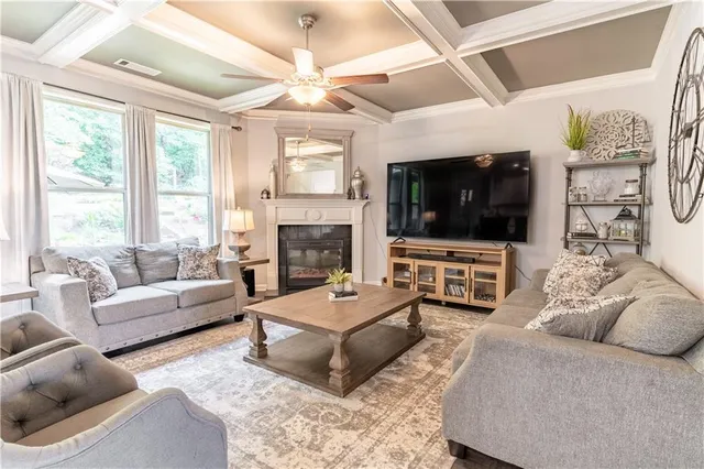 a living room with furniture a large window and a fireplace