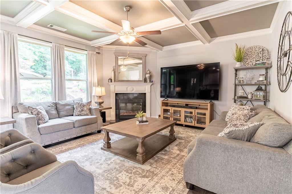 3041 Vista Ridge Braselton, GA 30517 - Photo 10 of 56 a living room with furniture a flat screen tv and a fireplace