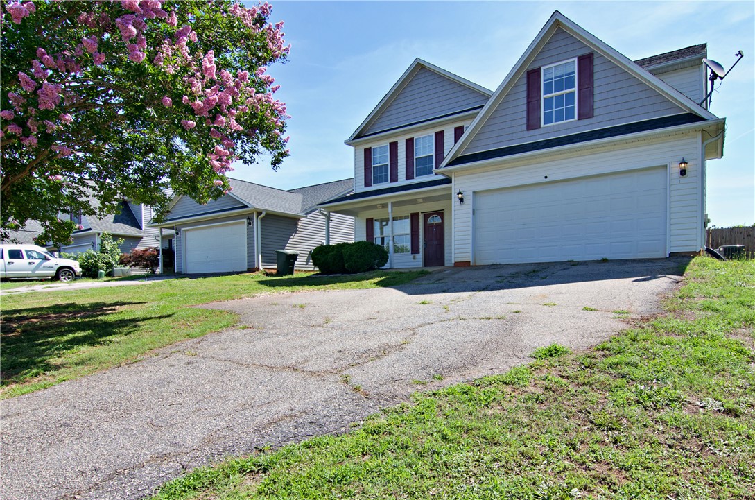 305 North Chestnut Street Seneca, SC 29678 - Photo 3 of 44 A classic facade with a spacious two-car garage, welcoming residents and guests with charming curb appeal.
