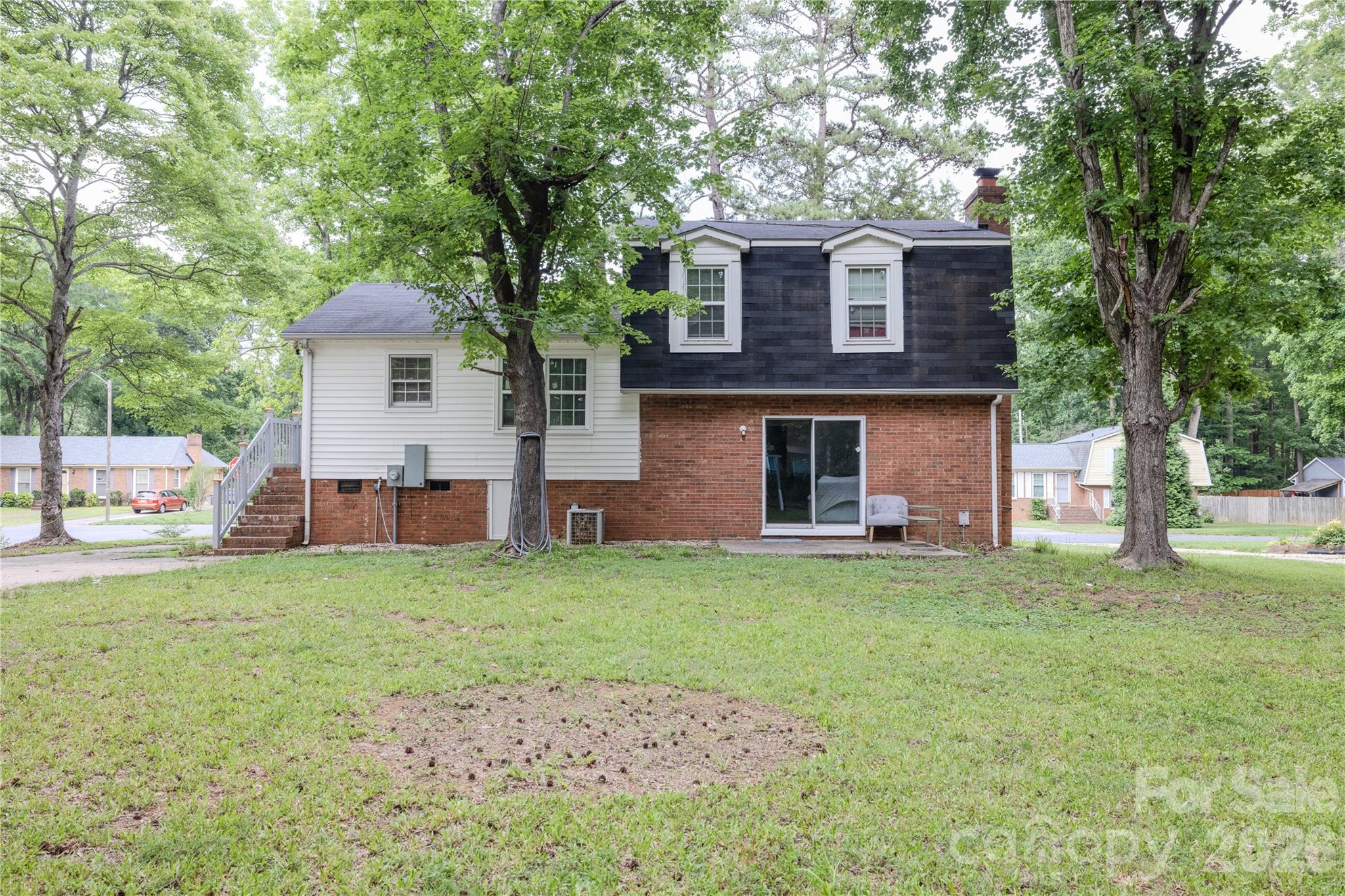 2545 Cedarwild Road Charlotte, NC 28212 - Photo 25 of 25 a front view of a house with a garden and trees