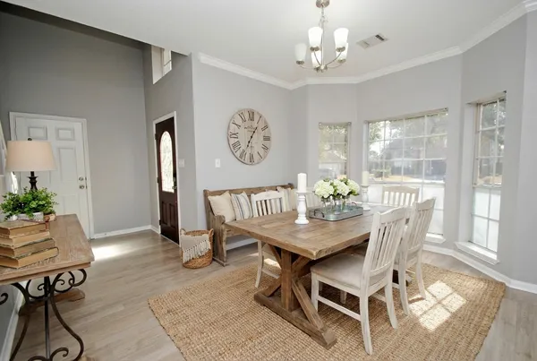 a view of a dining room with furniture window and wooden floor