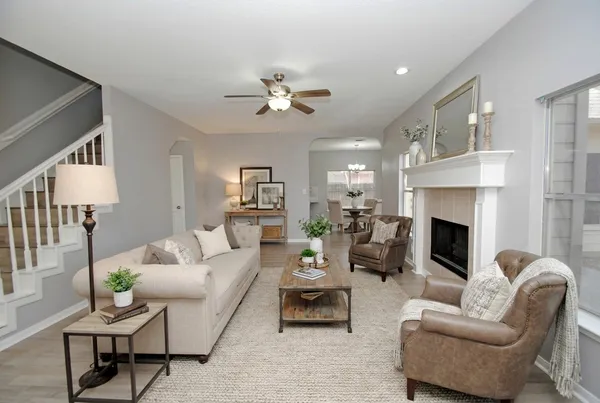 a living room with furniture fireplace and a fireplace