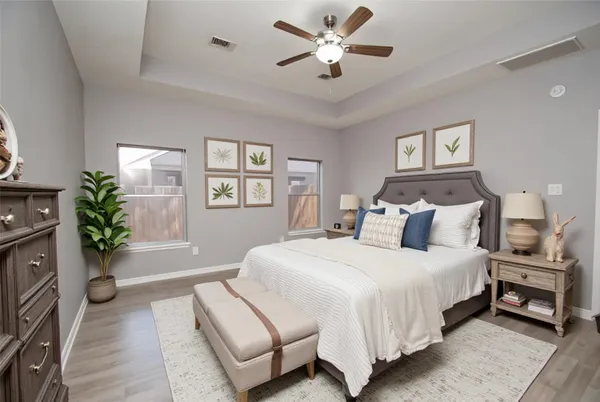 a spacious bedroom with a bed and a chandelier