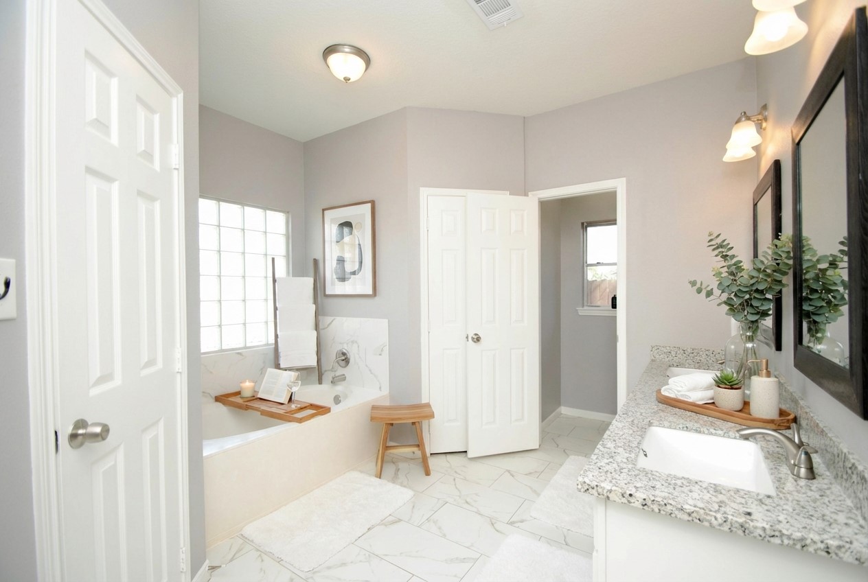 7514 Danehill Drive Spring, TX 77389 - Photo 10 of 19 a spacious bedroom with a bed a couch and a potted plant