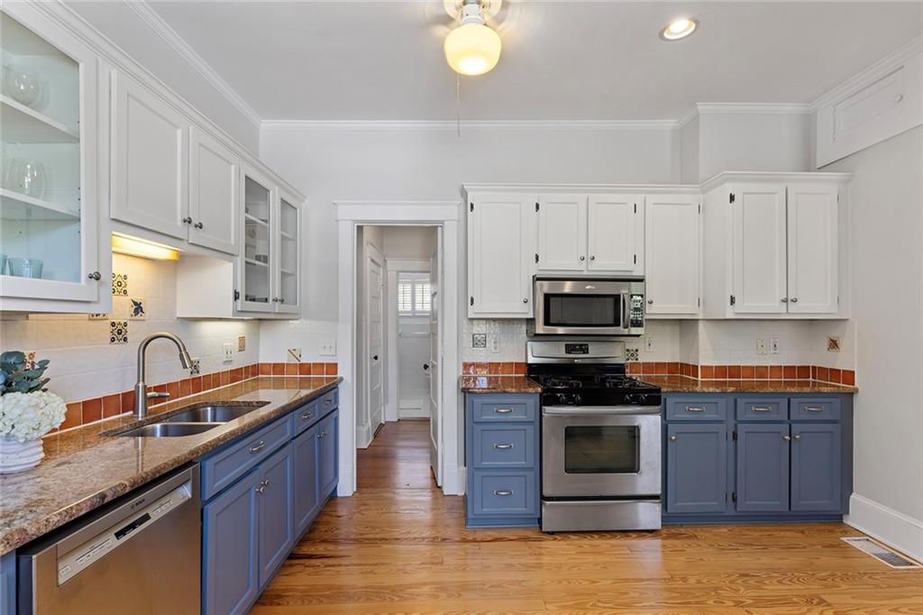 320 Ferguson Street Northeast Atlanta, GA 30307 - Photo 14 of 28 a kitchen with stainless steel appliances granite countertop a stove a sink and a refrigerator