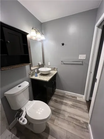a bathroom with a sink toilet and mirror