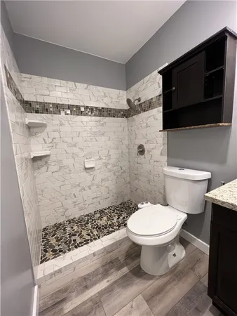a bathroom with a toilet and a shower