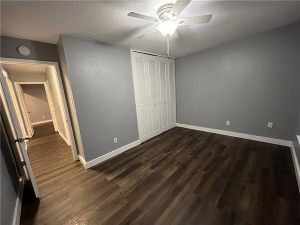 wooden floor in an empty room with a mirror