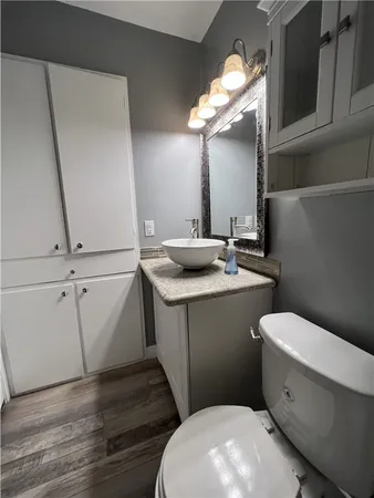 a bathroom with a sink a toilet and a mirror