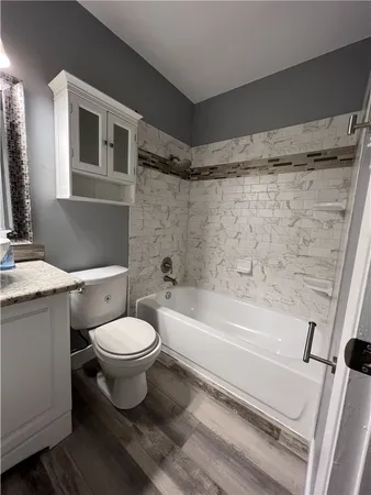 a bathroom with a toilet a sink and bathtub