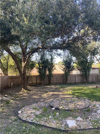 a view of a yard with a house in the background