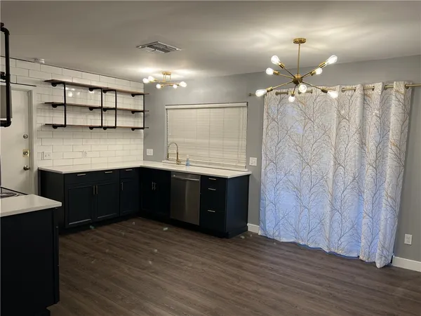 a kitchen with a sink and cabinets