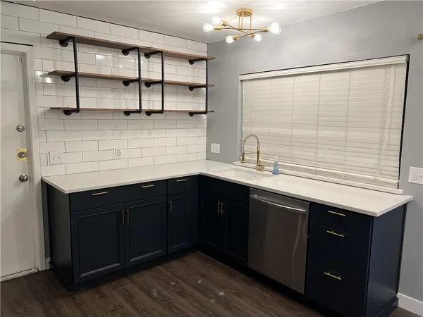 a kitchen with a sink and cabinets