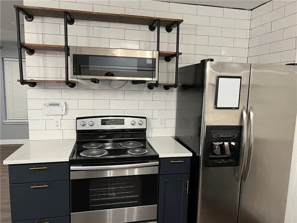 a stove top oven sitting inside of a kitchen