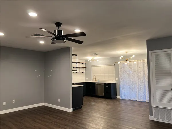 a view of a room with kitchen and window