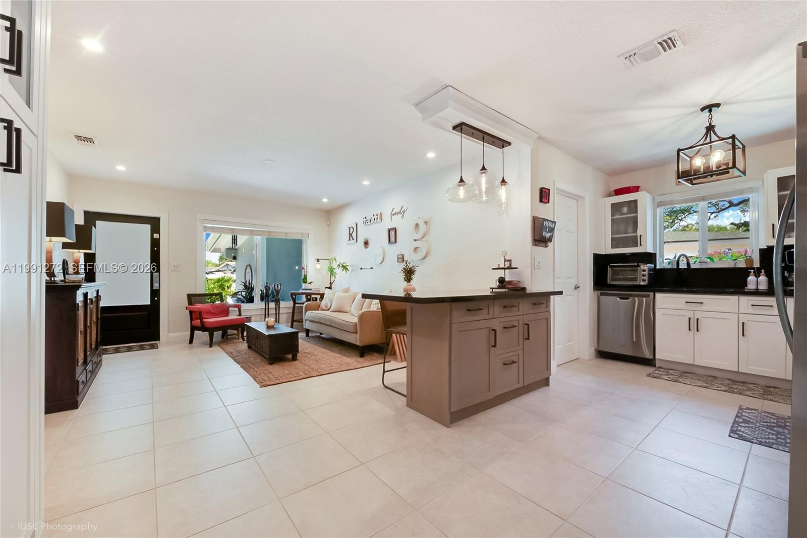 8535 Southwest 97th Road Miami, FL 33173 - Photo 5 of 28 a view of a living room kitchen and a chandelier