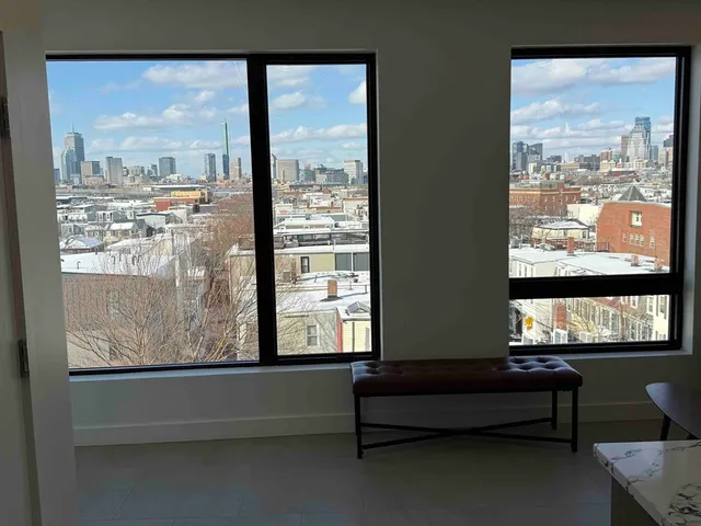 a view of a large window with a bench in front of building