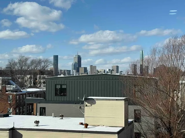 a view of roof with city