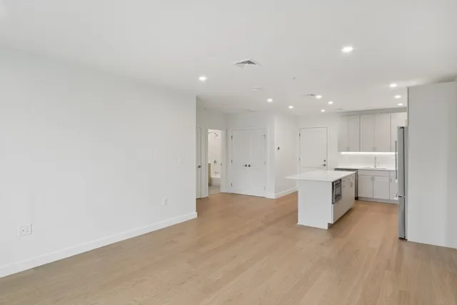 a view of a kitchen with a sink and white cabinets