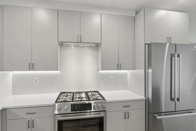 a kitchen with a stove and a refrigerator