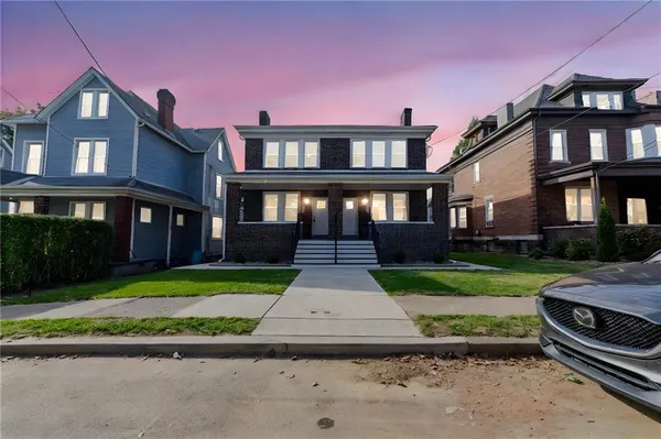 a front view of a house with a yard