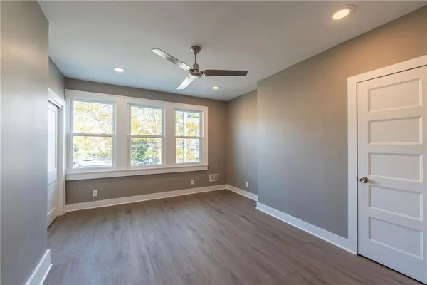 a bedroom with a large bed and a flat screen tv