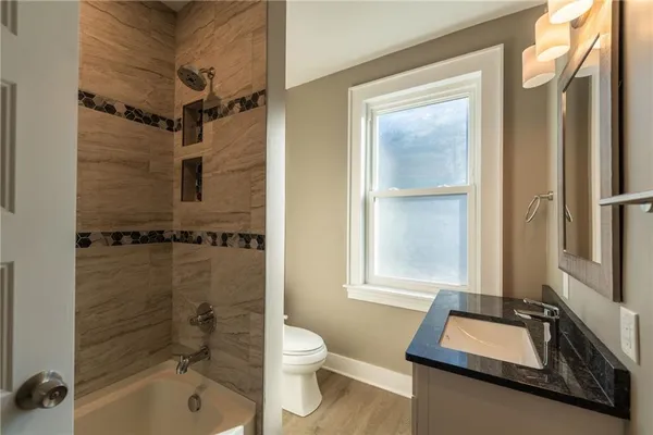 a bathroom with a bathtub and shower