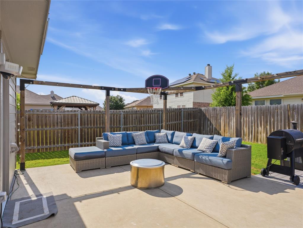 12724 Carpenter Lane Rhome, TX 76078 - Photo 26 of 37 Expansive concrete patio area featuring a wooden pergola structure