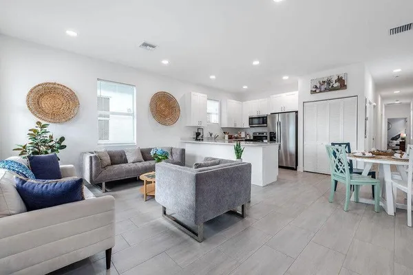 a living room with furniture kitchen and a table