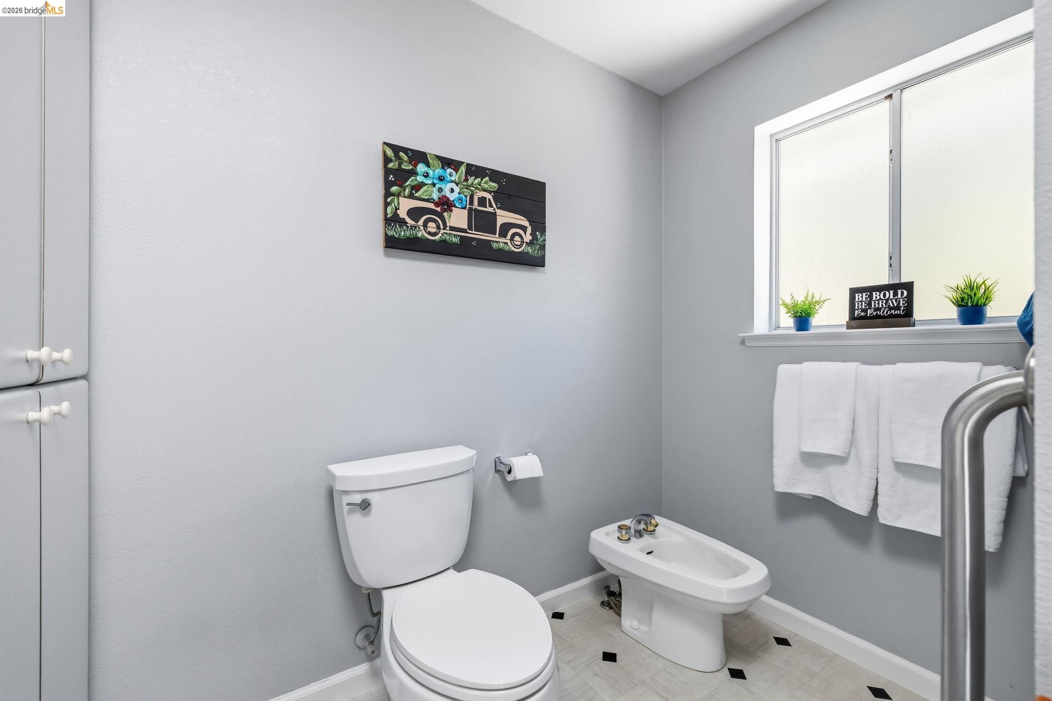18570 Pradera Real Road Sonora, CA 95370 - Photo 27 of 66 Built-in cabinetry, dual-pane window, linoleum flooring with dark accents, shower, bidet, and toilet