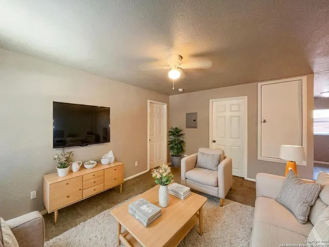 a living room with furniture and a flat screen tv