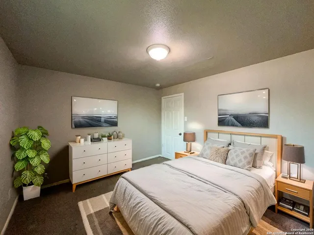 a bedroom with furniture and a flat screen tv