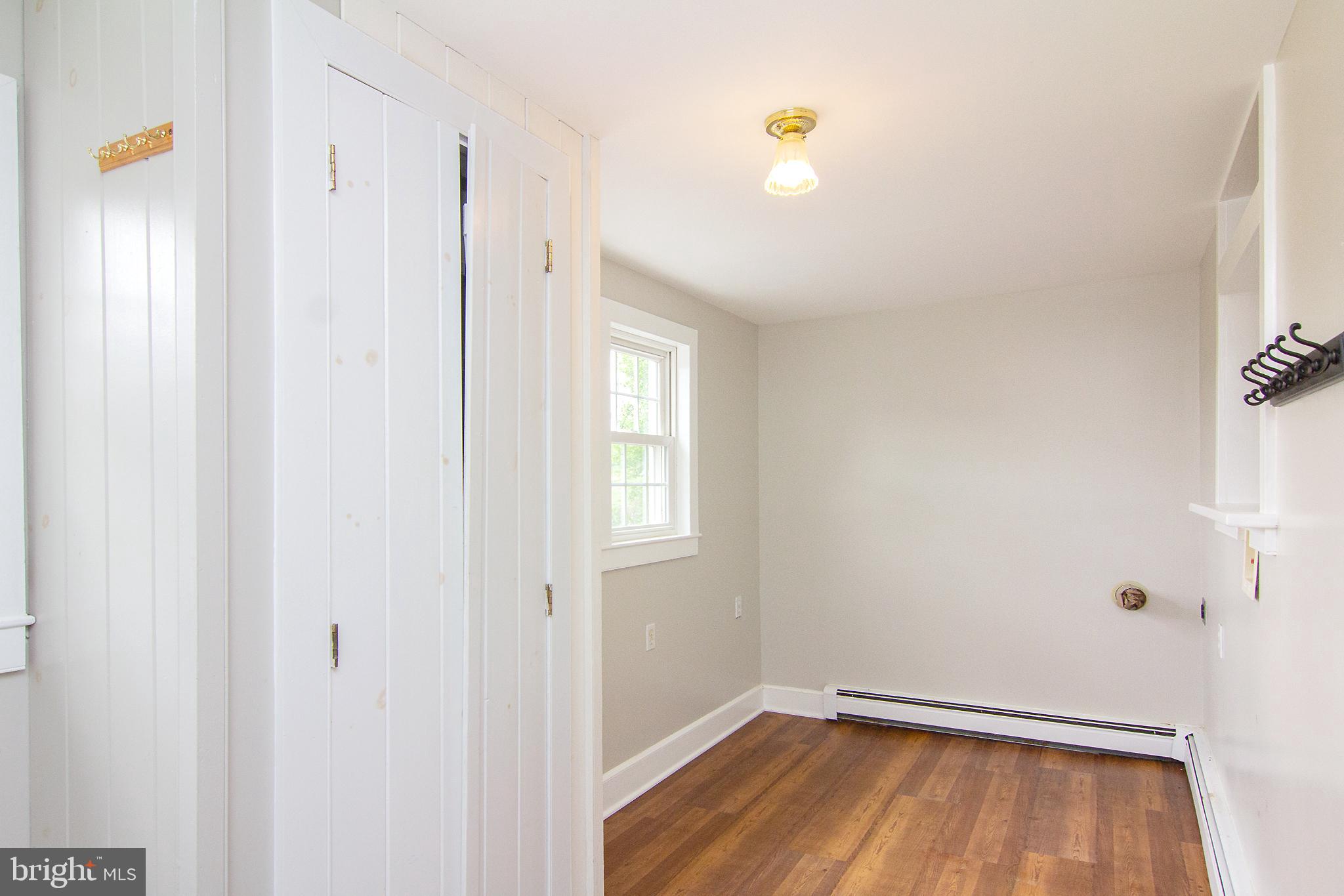 10121 B Clemsonville Road Union Bridge, MD 21791 - Photo 13 of 41 a view of a room with wooden floor and a window