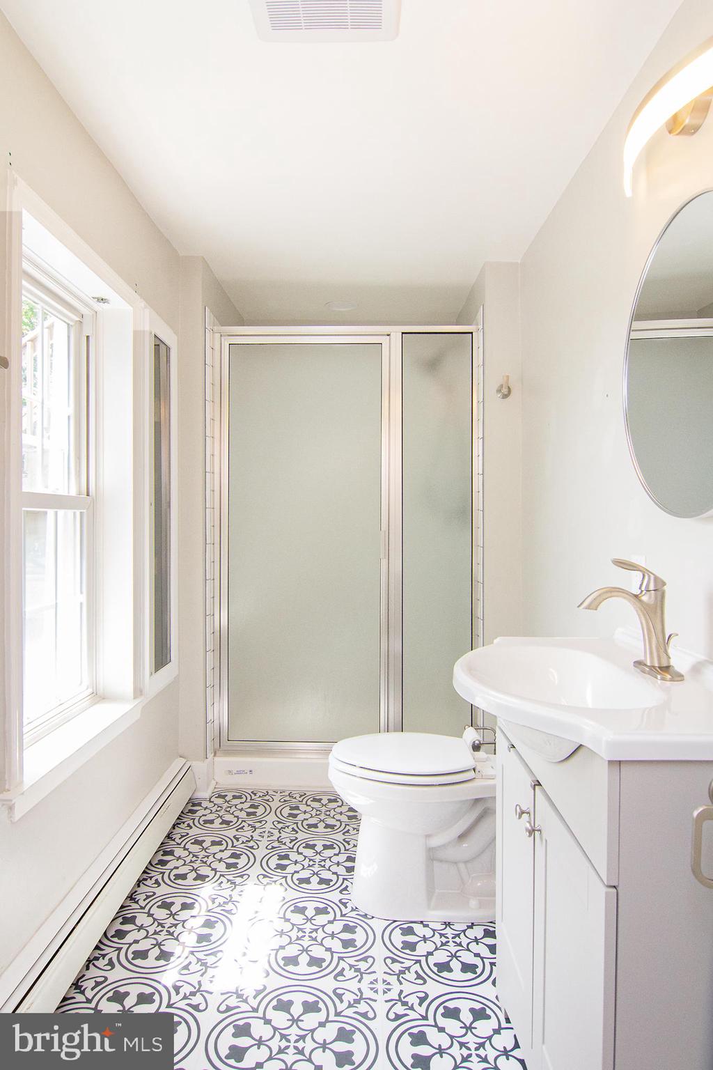 10121 B Clemsonville Road Union Bridge, MD 21791 - Photo 15 of 41 a bathroom with a sink toilet a mirror and shower