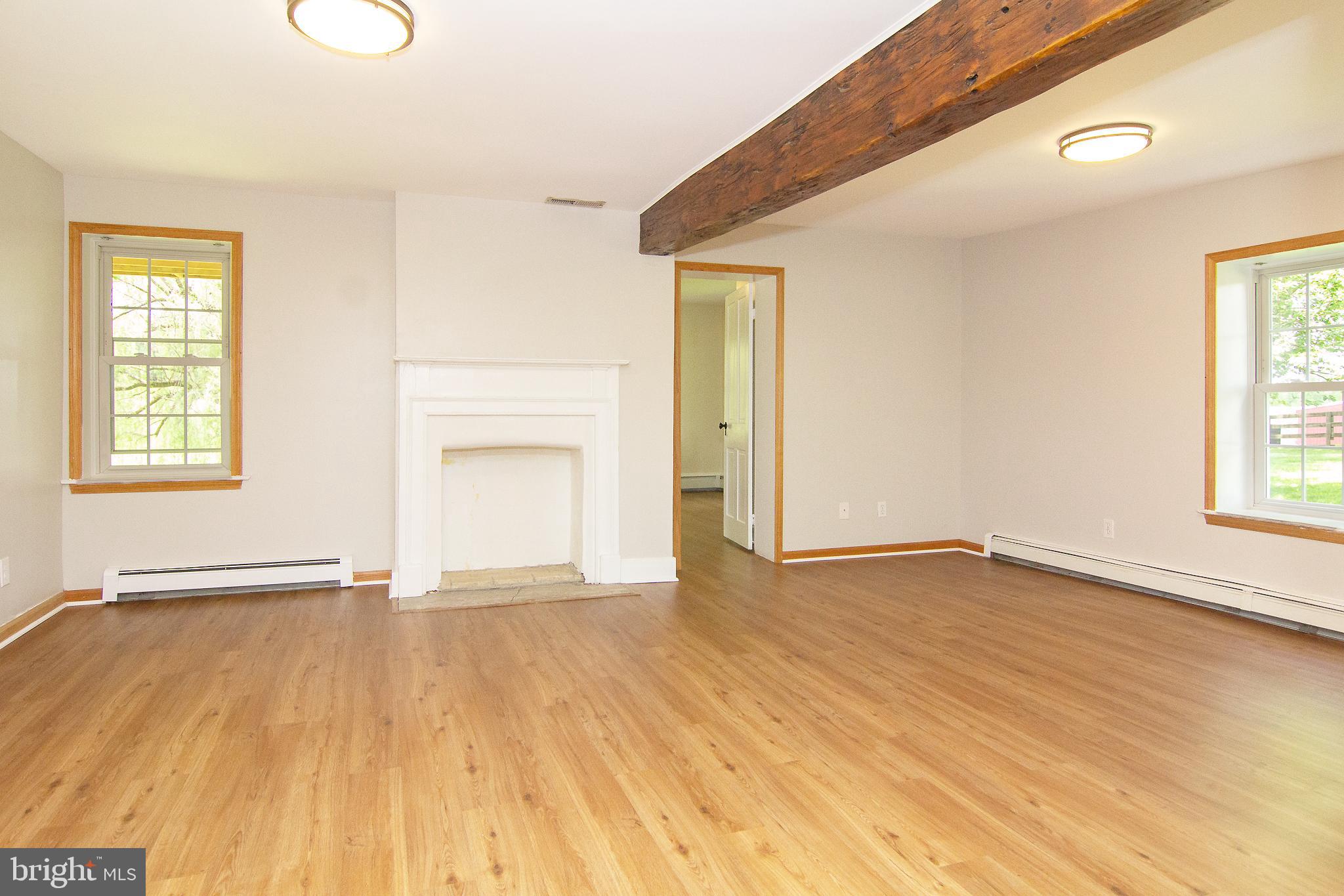 10121 B Clemsonville Road Union Bridge, MD 21791 - Photo 16 of 41 an empty room with wooden floor and windows