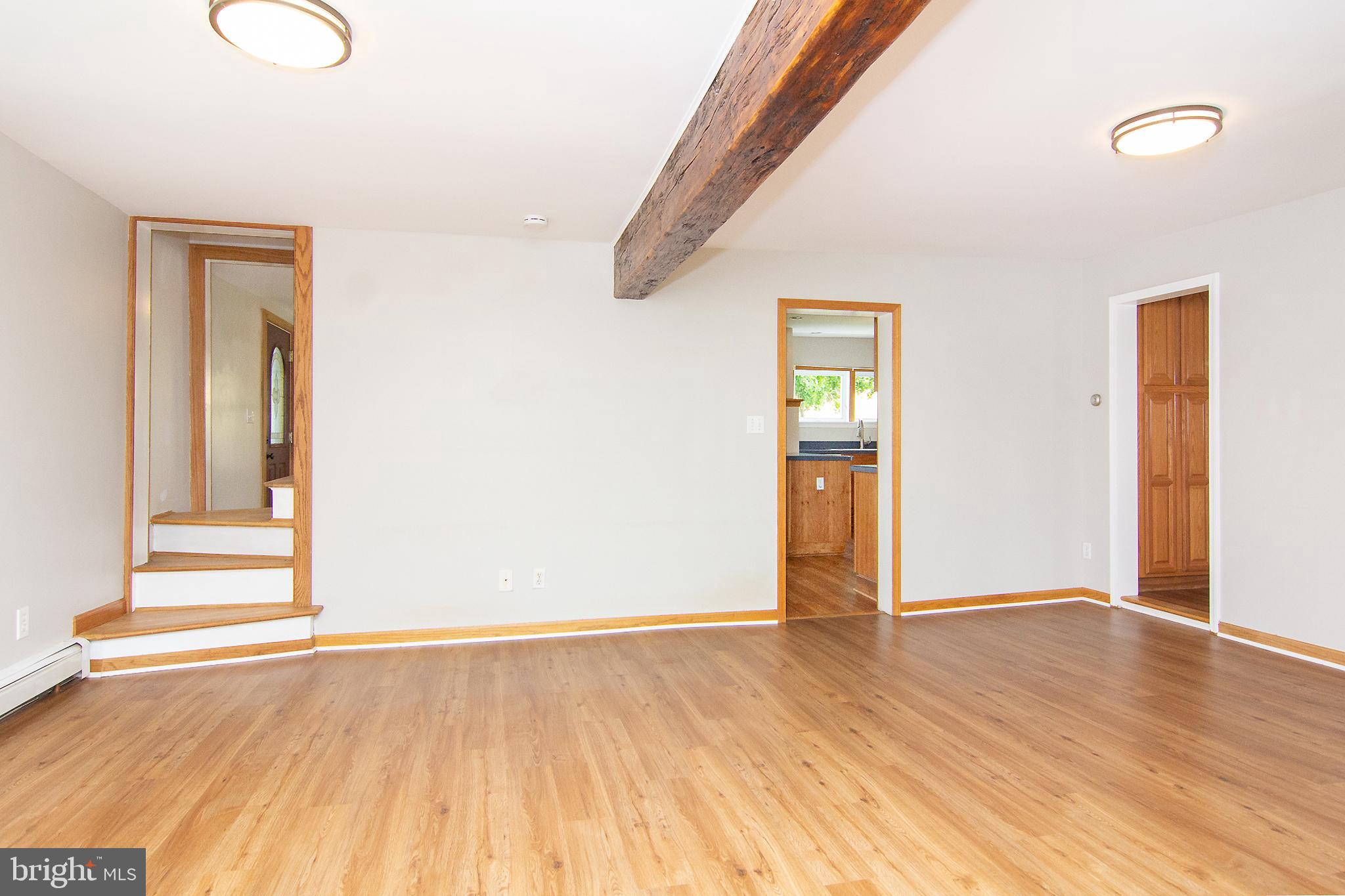 10121 B Clemsonville Road Union Bridge, MD 21791 - Photo 17 of 41 an empty room with wooden floor and windows