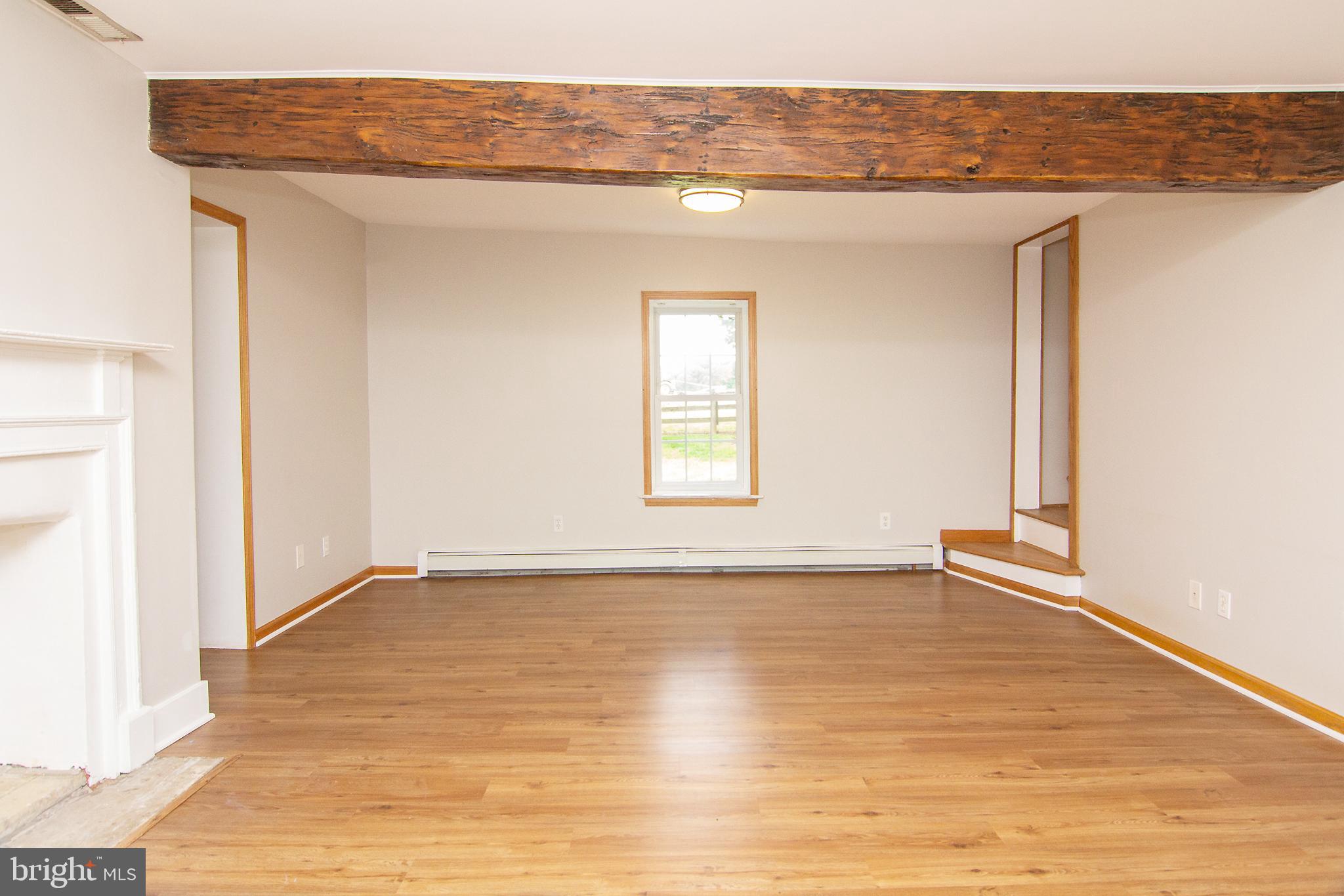 10121 B Clemsonville Road Union Bridge, MD 21791 - Photo 18 of 41 a view of an empty room with wooden floor and a window