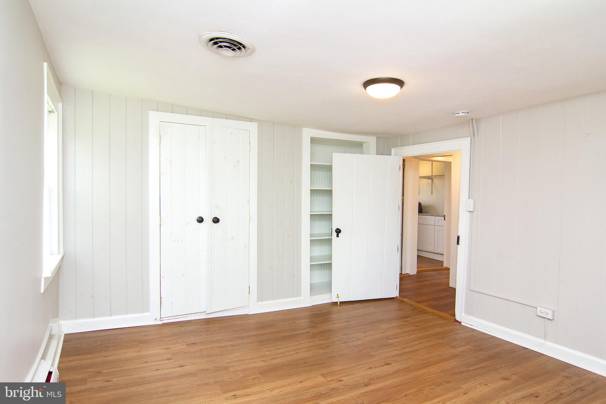 10121 B Clemsonville Road Union Bridge, MD 21791 - Photo 29 of 41 an empty room with wooden floor and closet