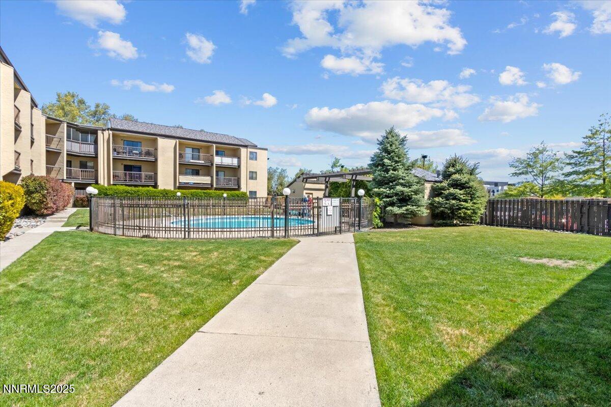a view of a house with backyard and a garden