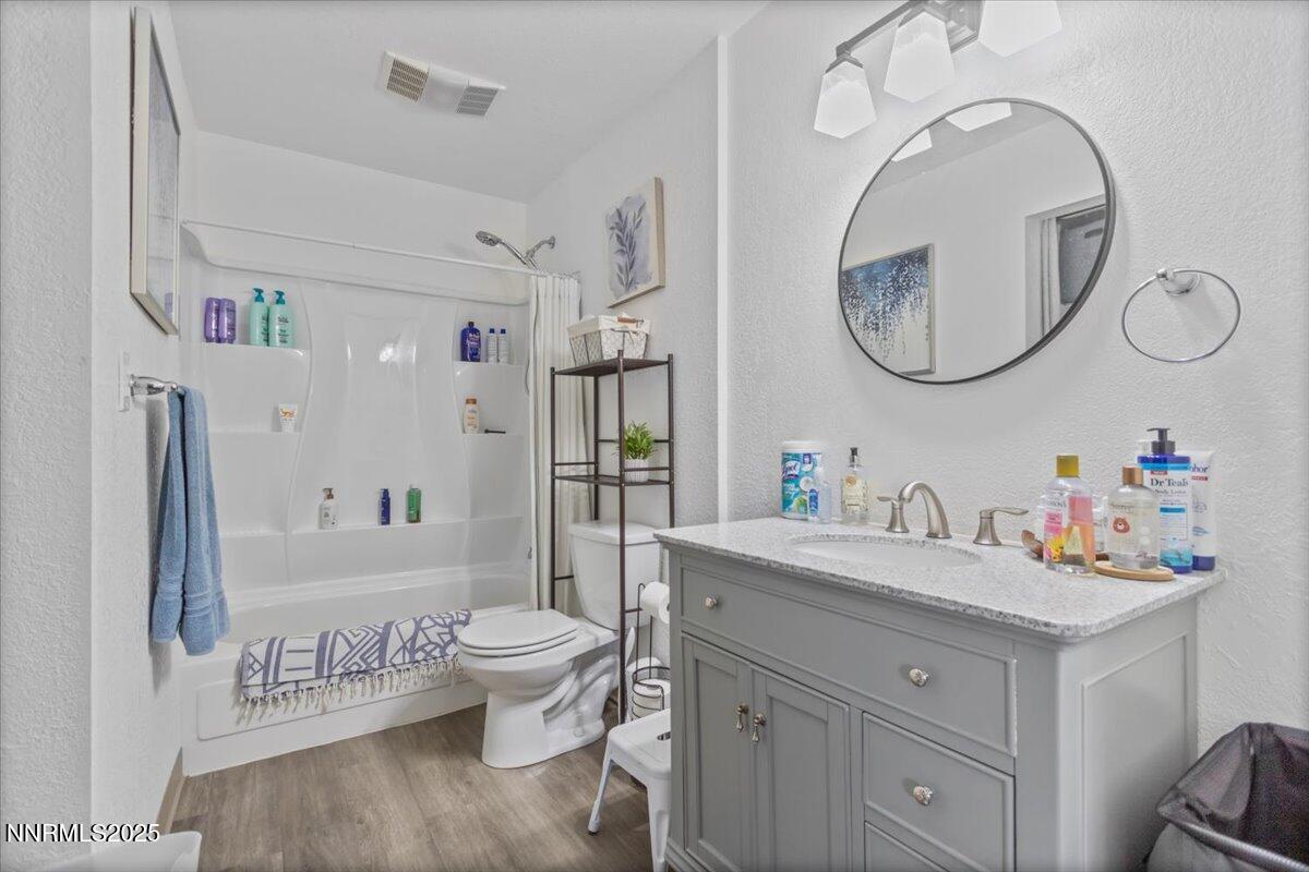 2450 Lymbery Street, Unit 230 Reno, NV 89509 - Photo 9 of 24 a bathroom with a toilet sink and mirror